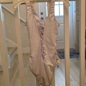 White one piece bathing suit criss cross ties front, back and sides